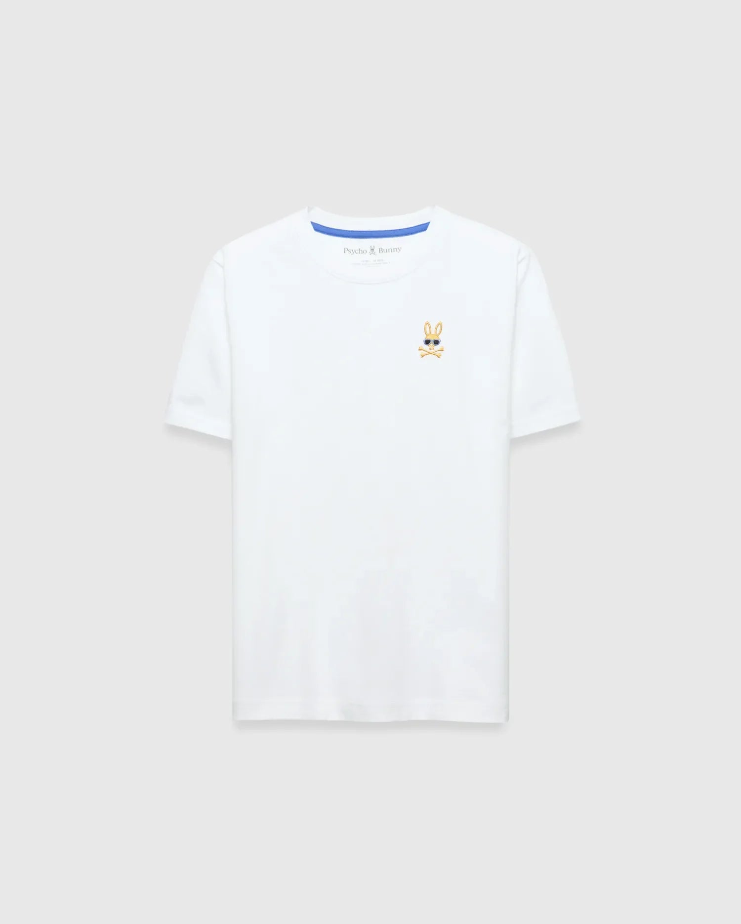 Kids Sunny Chest Graphic Tee, a classic fit white jersey t-shirt featuring a small, embroidered gold and black Psycho Bunny skull logo with sunglasses on the left chest and blue neck tape.