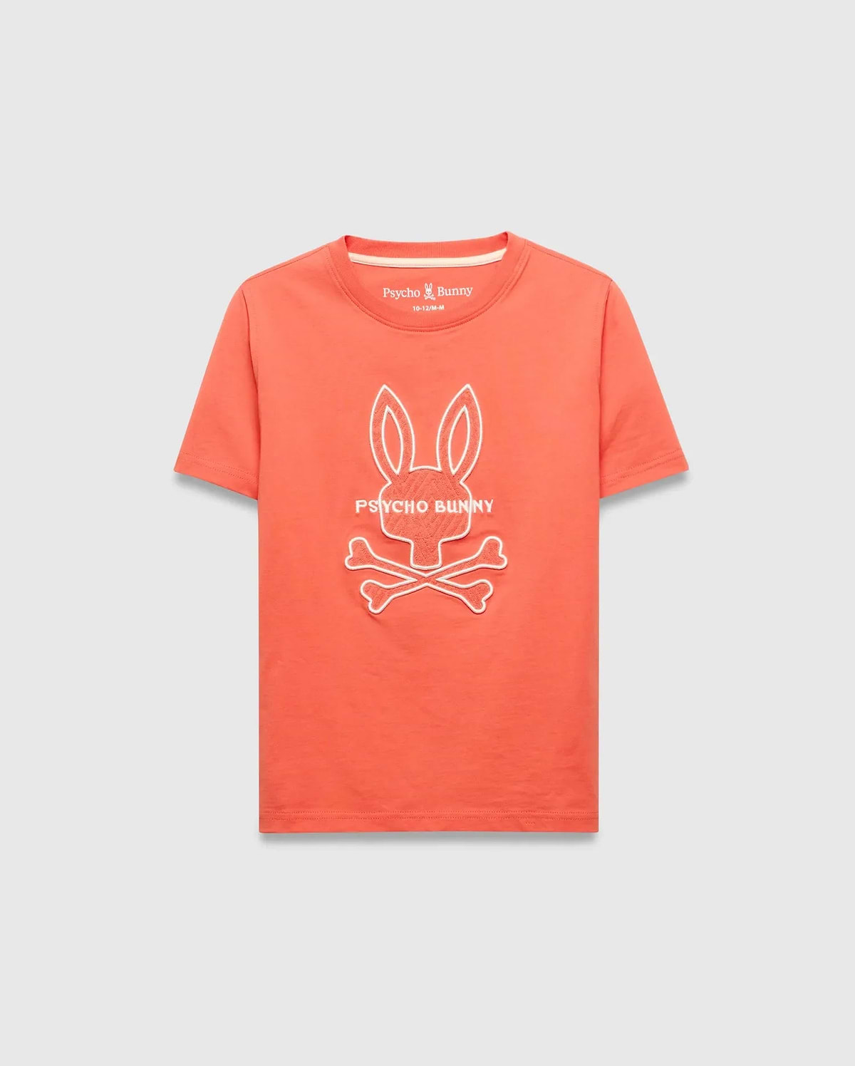 Kids Craig Graphic Tee, a classic fit coral jersey knit t-shirt featuring a large white embroidered Psycho Bunny skull and crossbones logo with PSYCHO BUNNY text on the chest.