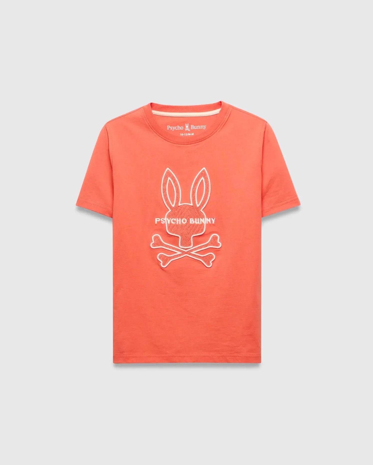 Kids Craig Graphic Tee, a classic fit coral jersey knit t-shirt featuring a large white embroidered Psycho Bunny skull and crossbones logo with PSYCHO BUNNY text on the chest.