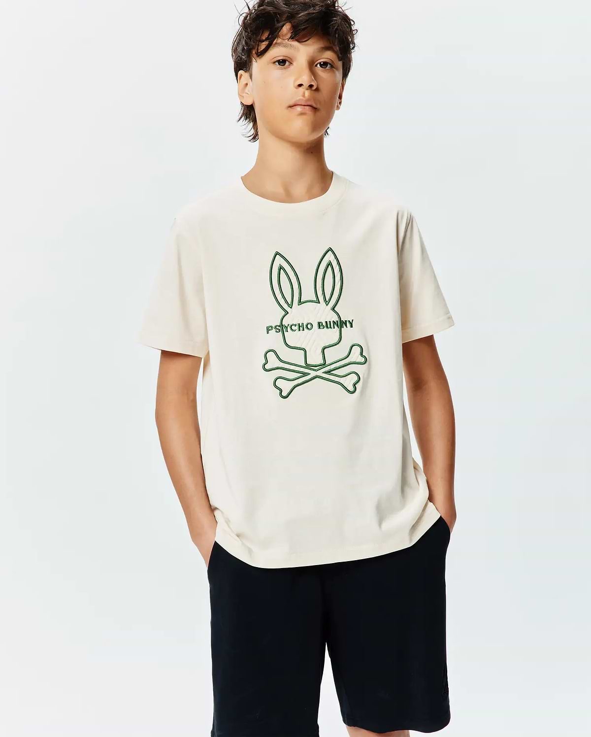 Kids Craig Graphic Tee in cream jersey, featuring a relaxed fit with a prominent green embroidered Psycho Bunny skull and crossbones logo on the center chest. (2)