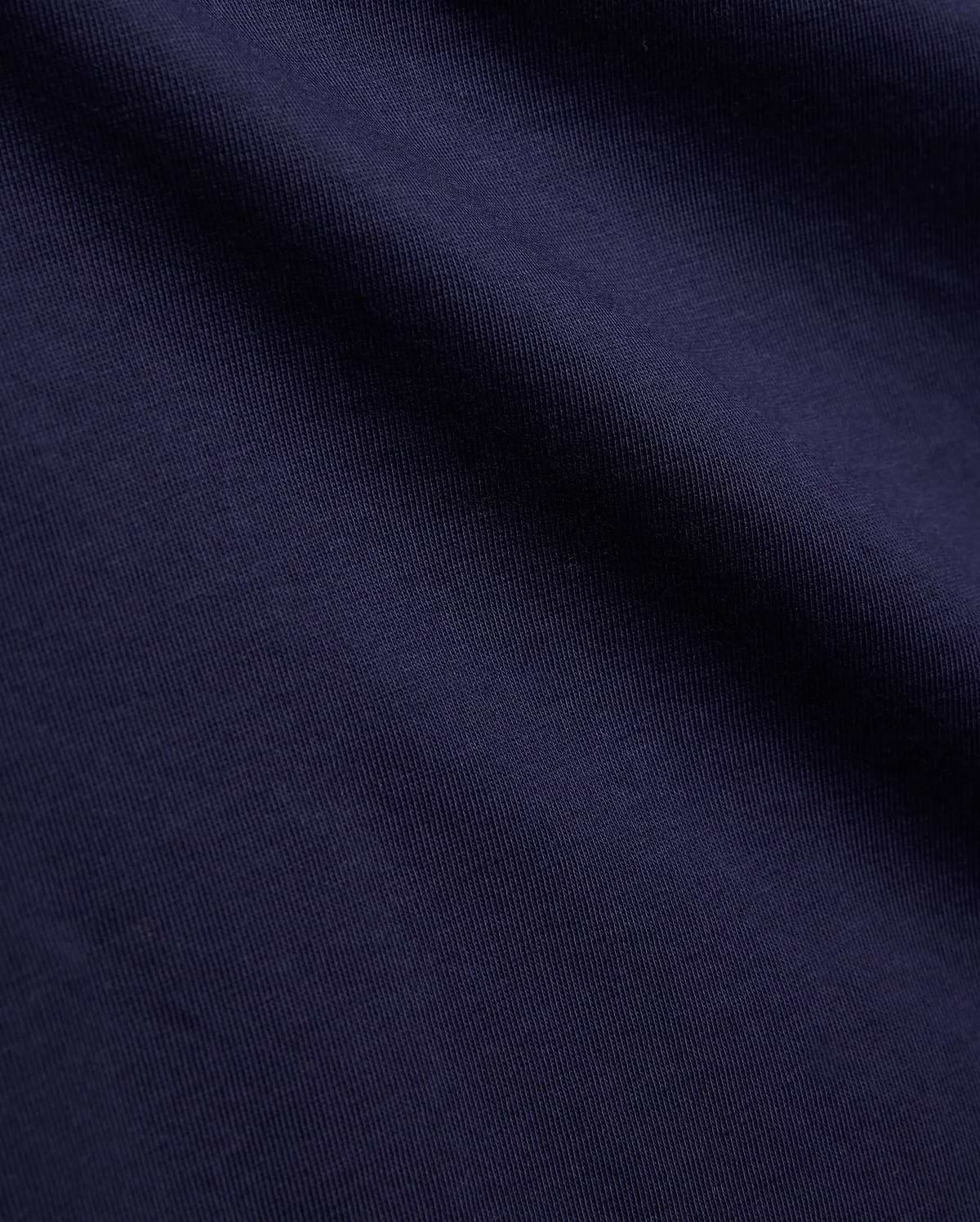 Psycho Bunny Kids Tanner Graphic Tee, crafted from premium deep navy blue jersey knit fabric, showcasing a fine vertical rib texture, smooth feel, and soft, natural drape.