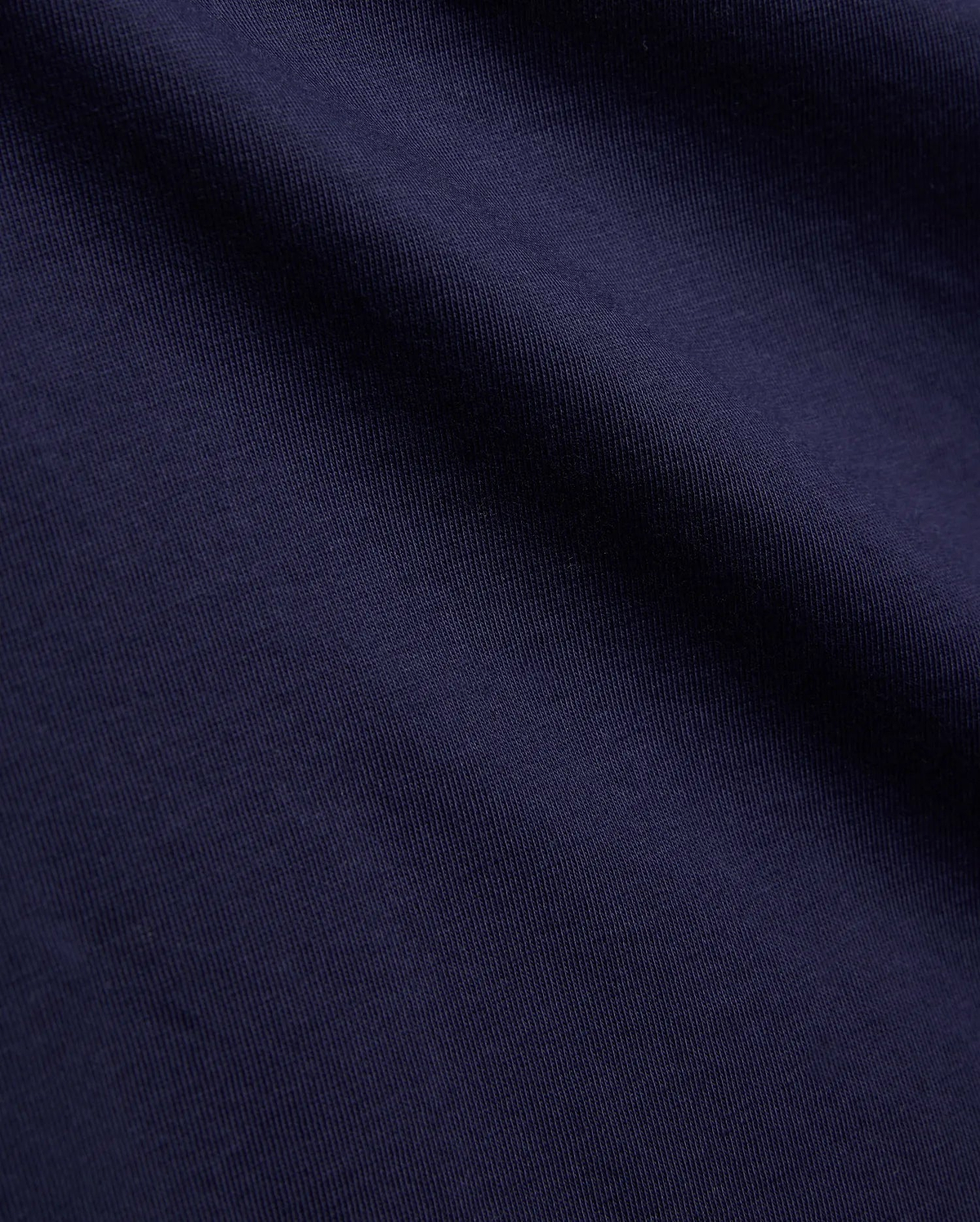 Psycho Bunny Kids Tanner Graphic Tee, crafted from premium deep navy blue jersey knit fabric, showcasing a fine vertical rib texture, smooth feel, and soft, natural drape.