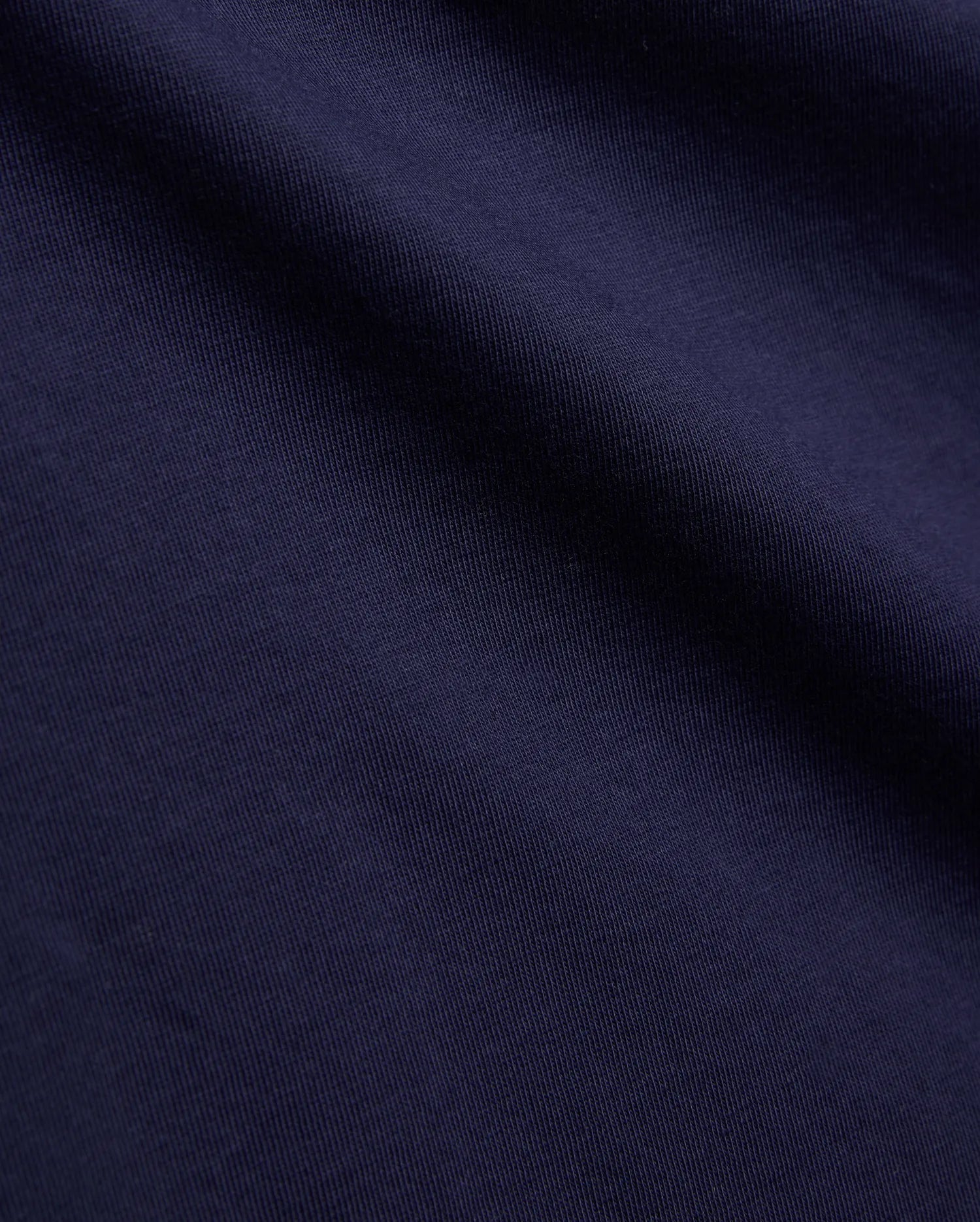 Psycho Bunny Kids Tanner Graphic Tee, crafted from premium deep navy blue jersey knit fabric, showcasing a fine vertical rib texture, smooth feel, and soft, natural drape.