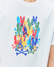 Kids Tanner Graphic Tee, a white classic fit jersey t-shirt featuring a large central graphic print of overlapping Psycho Bunny skull logos and crossbones in red, blue, yellow, green, and light blue.