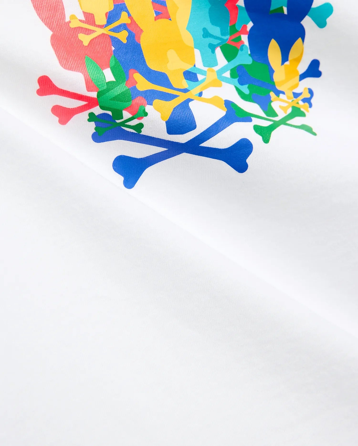 Kids Tanner Graphic Tee, white jersey t-shirt featuring a large, vibrant, overlapping Psycho Bunny skull and crossbones graphic print on the chest in red, green, blue, yellow, and light blue.