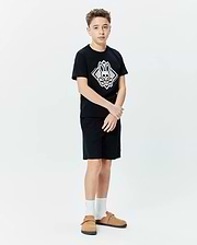 Kids Tobias Graphic Tee, black jersey knit, classic fit, featuring a large central white and grey Psycho Bunny skull and crossbones diamond graphic with vertical brand name.