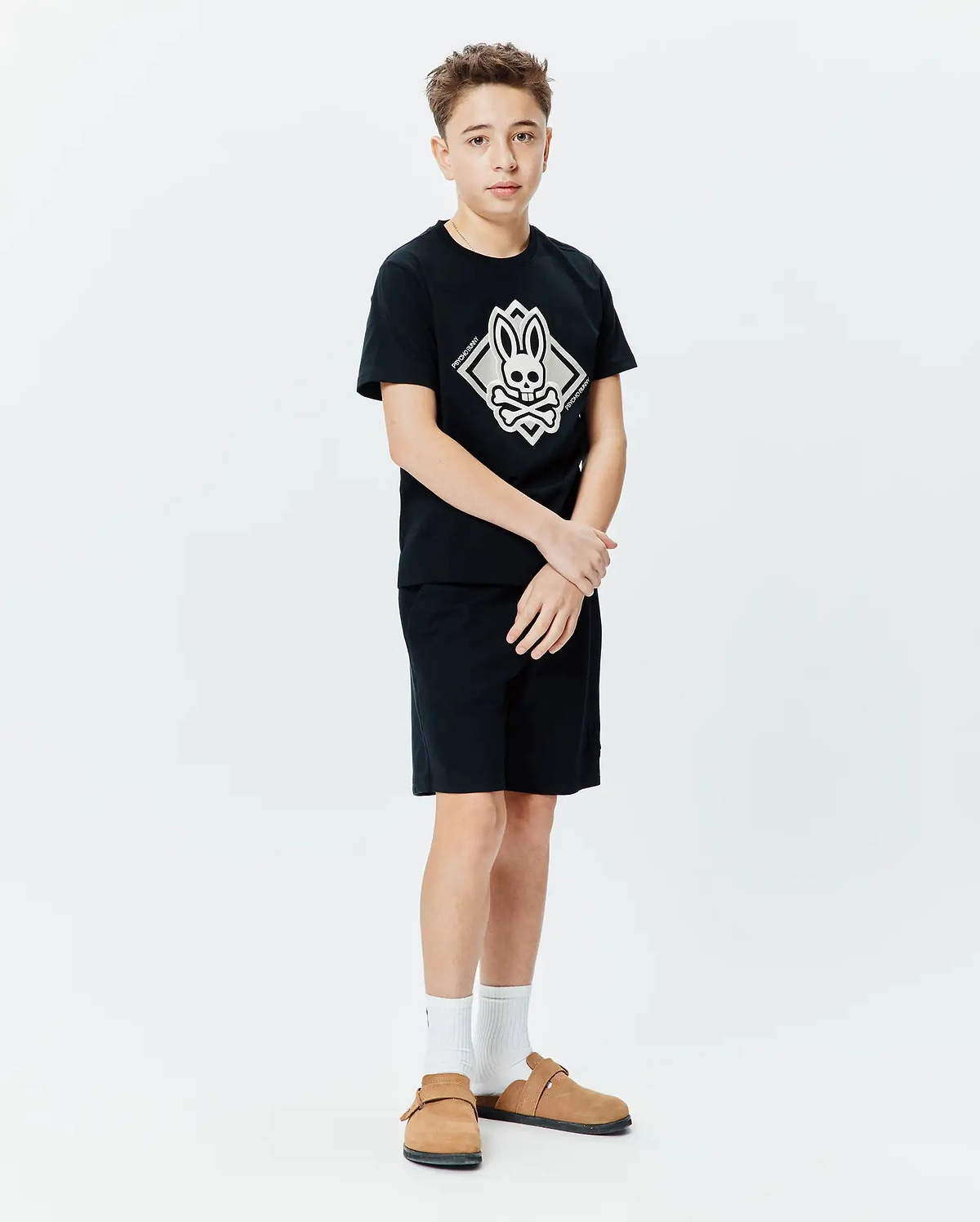 Kids Tobias Graphic Tee, black jersey knit, classic fit, featuring a large central white and grey Psycho Bunny skull and crossbones diamond graphic with vertical brand name.