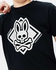 Black classic fit jersey Kids Tobias Graphic Tee with a large, central white embroidered Psycho Bunny skull and crossbones logo inside a diamond, featuring Psycho Bunny text.