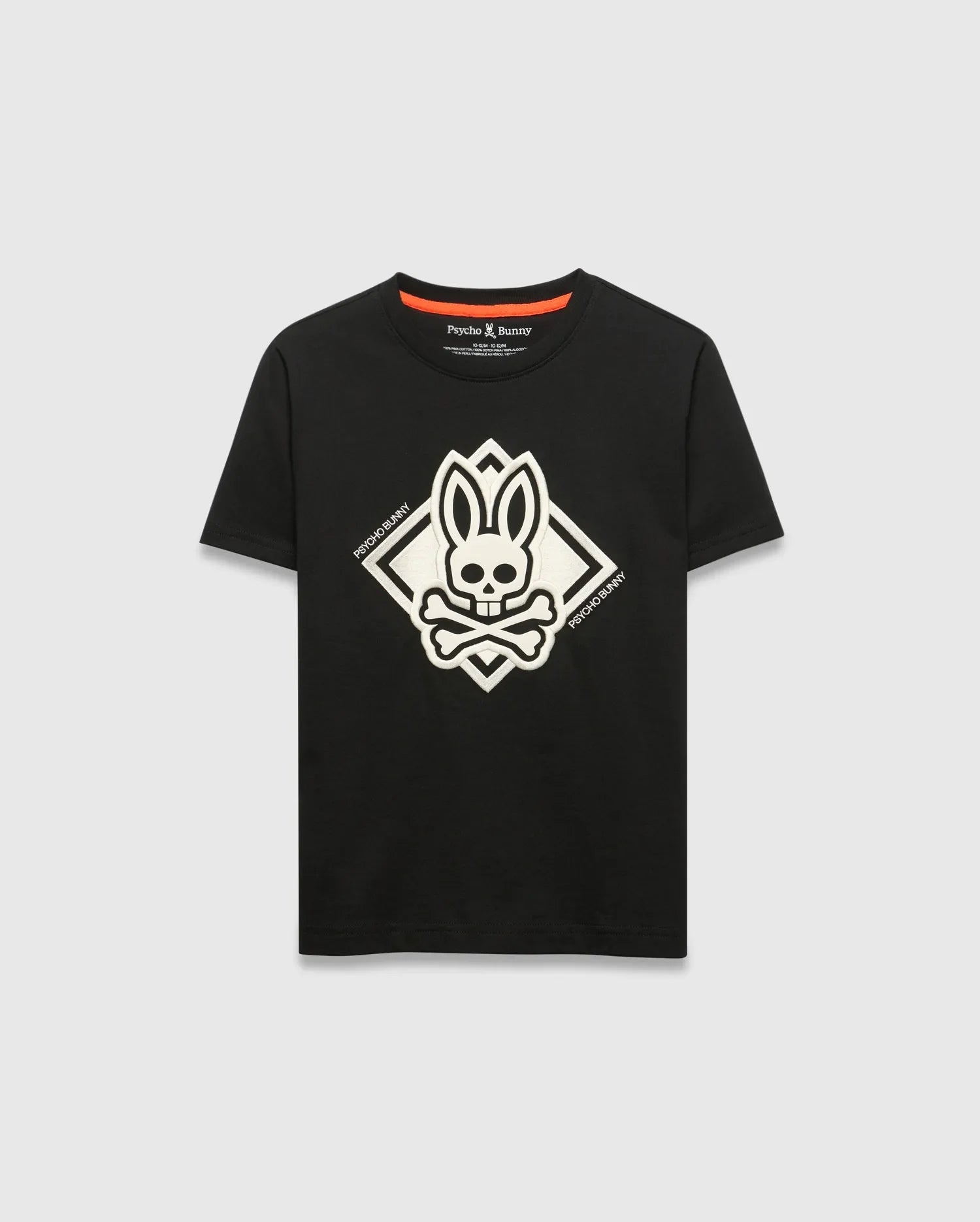 Kids Tobias Graphic Tee, black classic fit jersey t-shirt with a large central white bunny skull and crossbones graphic inside a diamond, flanked by Psycho Bunny text, and an orange inner neckline trim.
