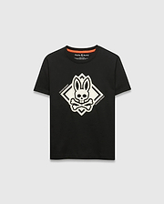 Kids Tobias Graphic Tee, black classic fit jersey t-shirt with a large central white bunny skull and crossbones graphic inside a diamond, flanked by Psycho Bunny text, and an orange inner neckline trim.