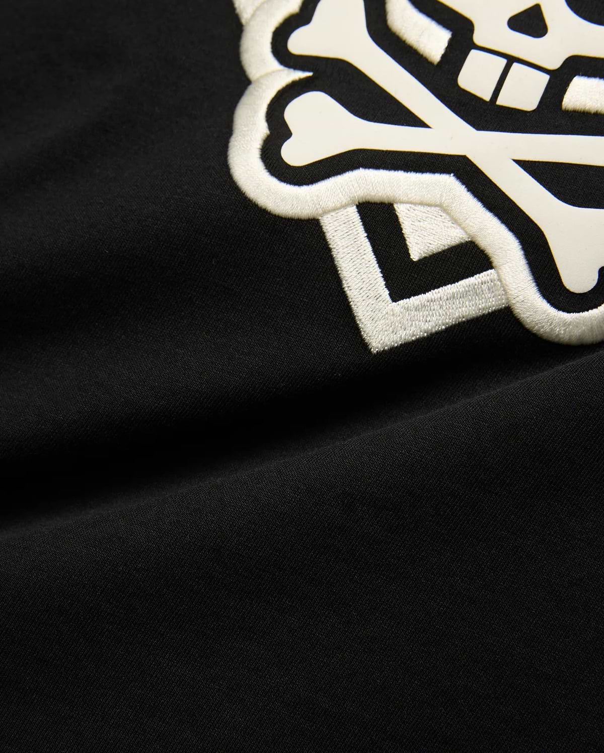 Kids Tobias Graphic Tee: Black jersey t-shirt with a large, prominent white embroidered and printed Psycho Bunny skull and crossbones logo on the chest.
