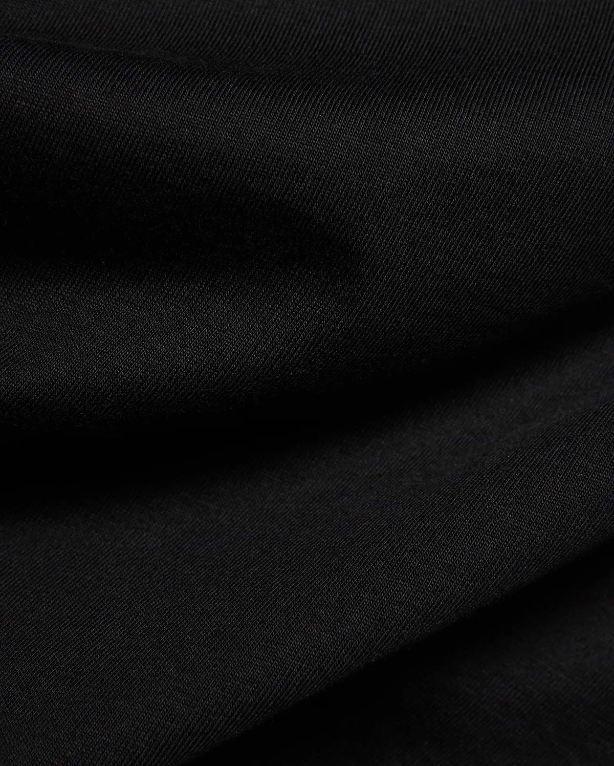 Psycho Bunny Kids Frank Back Graphic Tee in a rich black, soft jersey knit fabric with a subtle diagonal rib texture, featuring a bold back graphic.