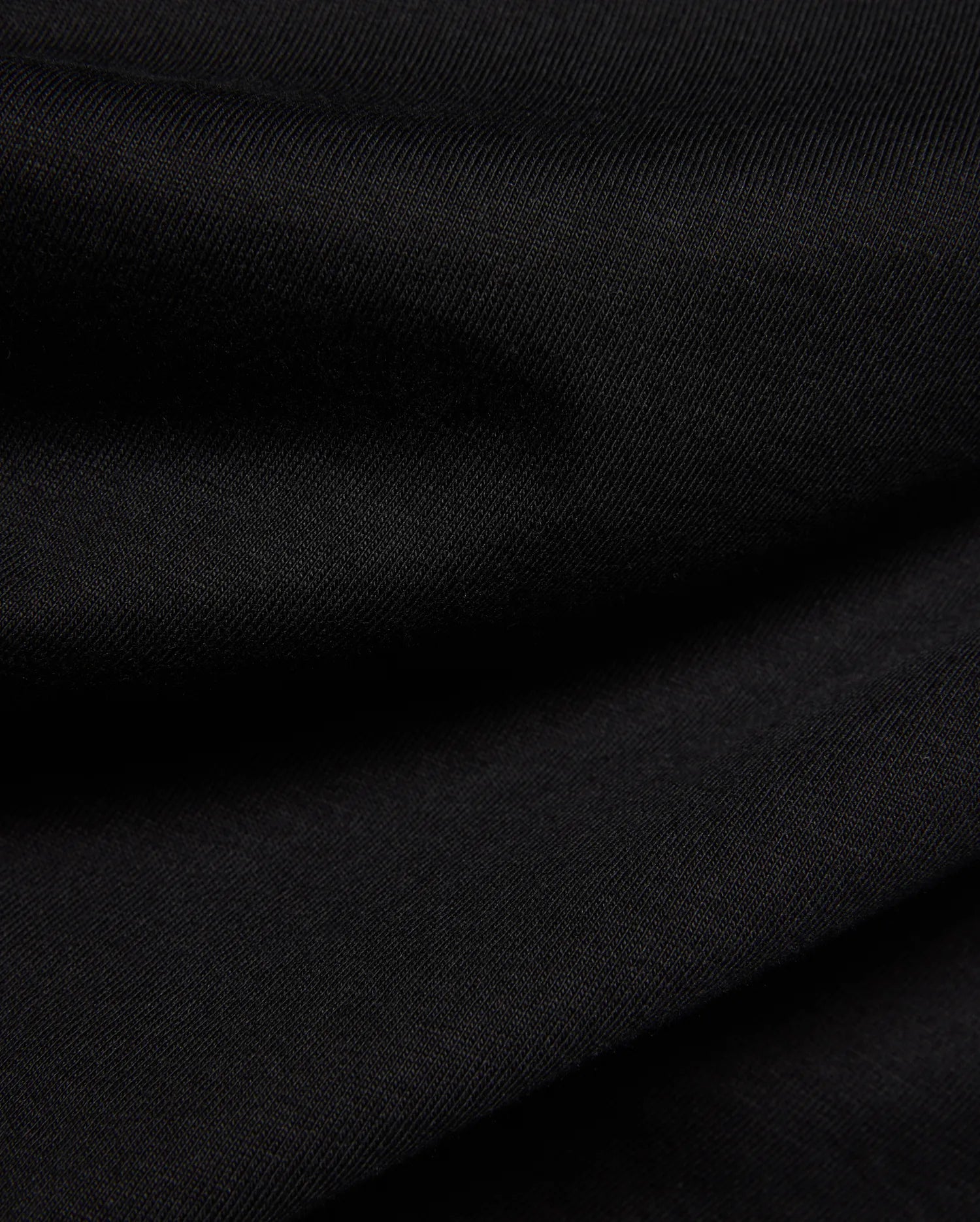 Psycho Bunny Kids Frank Back Graphic Tee in a rich black, soft jersey knit fabric with a subtle diagonal rib texture, featuring a bold back graphic.