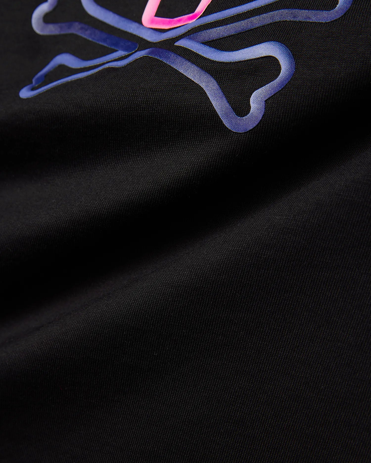 Kids Dayton Graphic Tee, black jersey t-shirt featuring a large, central raised Psycho Bunny skull logo graphic in vibrant neon pink and blue gradient, classic fit.