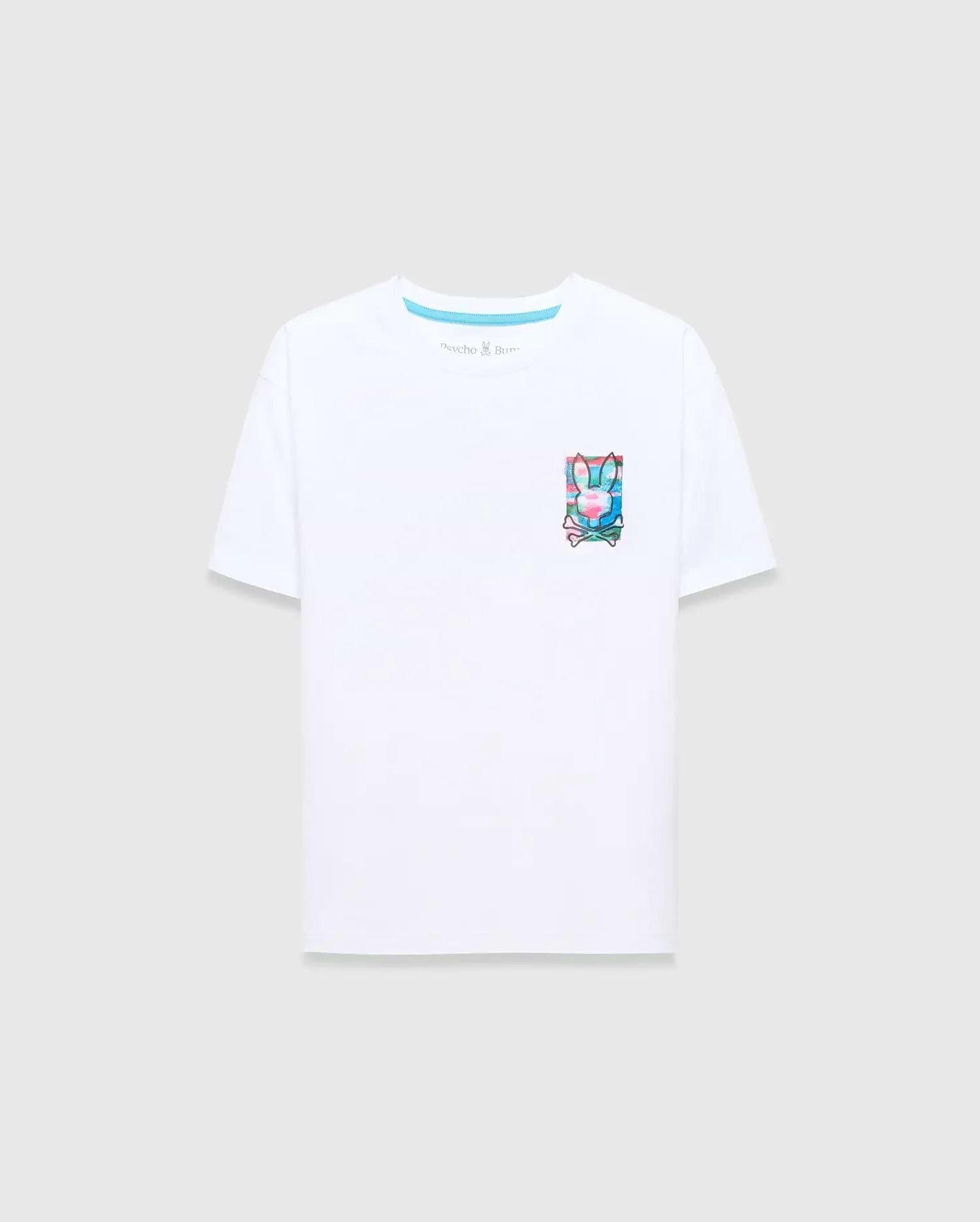 Kids Isaac Relaxed Fit Tee in crisp white jersey, featuring a vibrant, small graphic Psycho Bunny skull and crossbones logo print on the left chest with pink, blue, and green accents.
