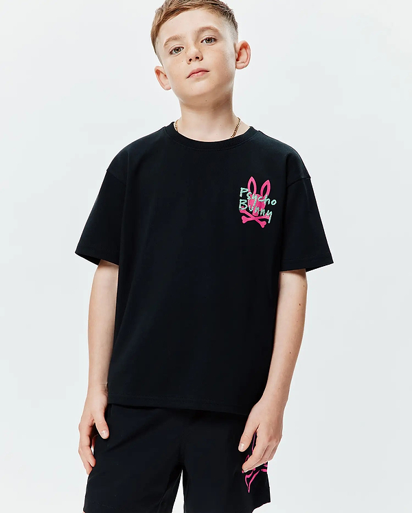 Kids Duncan Relaxed Fit Tee in black jersey knit, featuring a small graphic print of the pink bunny skull logo with green Psycho Bunny text on the left chest.