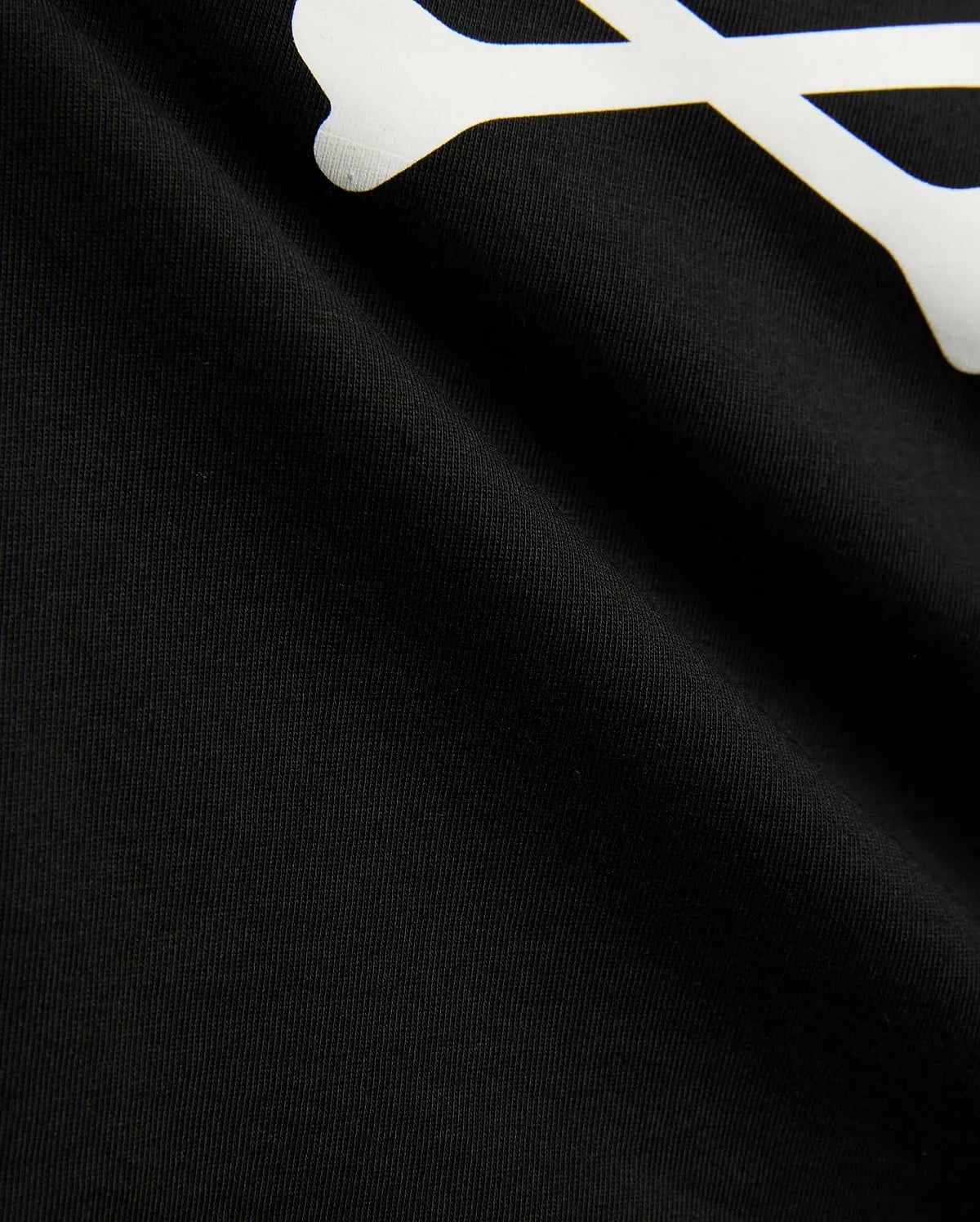 Kids Sunny Graphic Tee in black jersey knit, showcasing a large white graphic print of a bone, a key element of the iconic Psycho Bunny skull and crossbones logo.