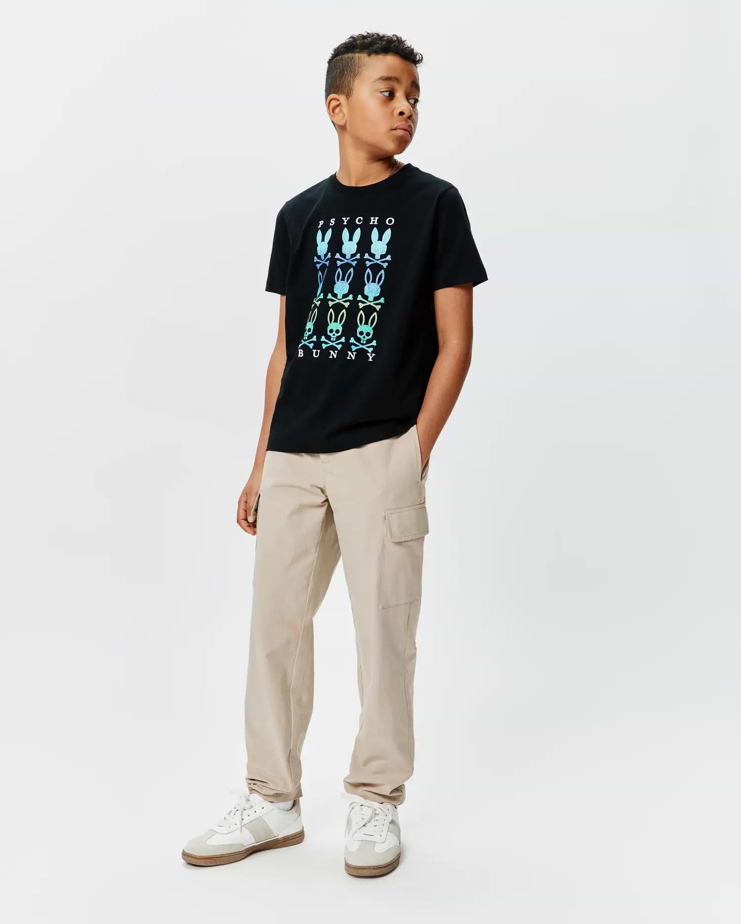 Kids Colt Graphic Tee, a black classic fit jersey t-shirt featuring a large center chest gradient graphic of PSYCHO BUNNY text and multiple bunny skull logos in blue, green, and yellow.