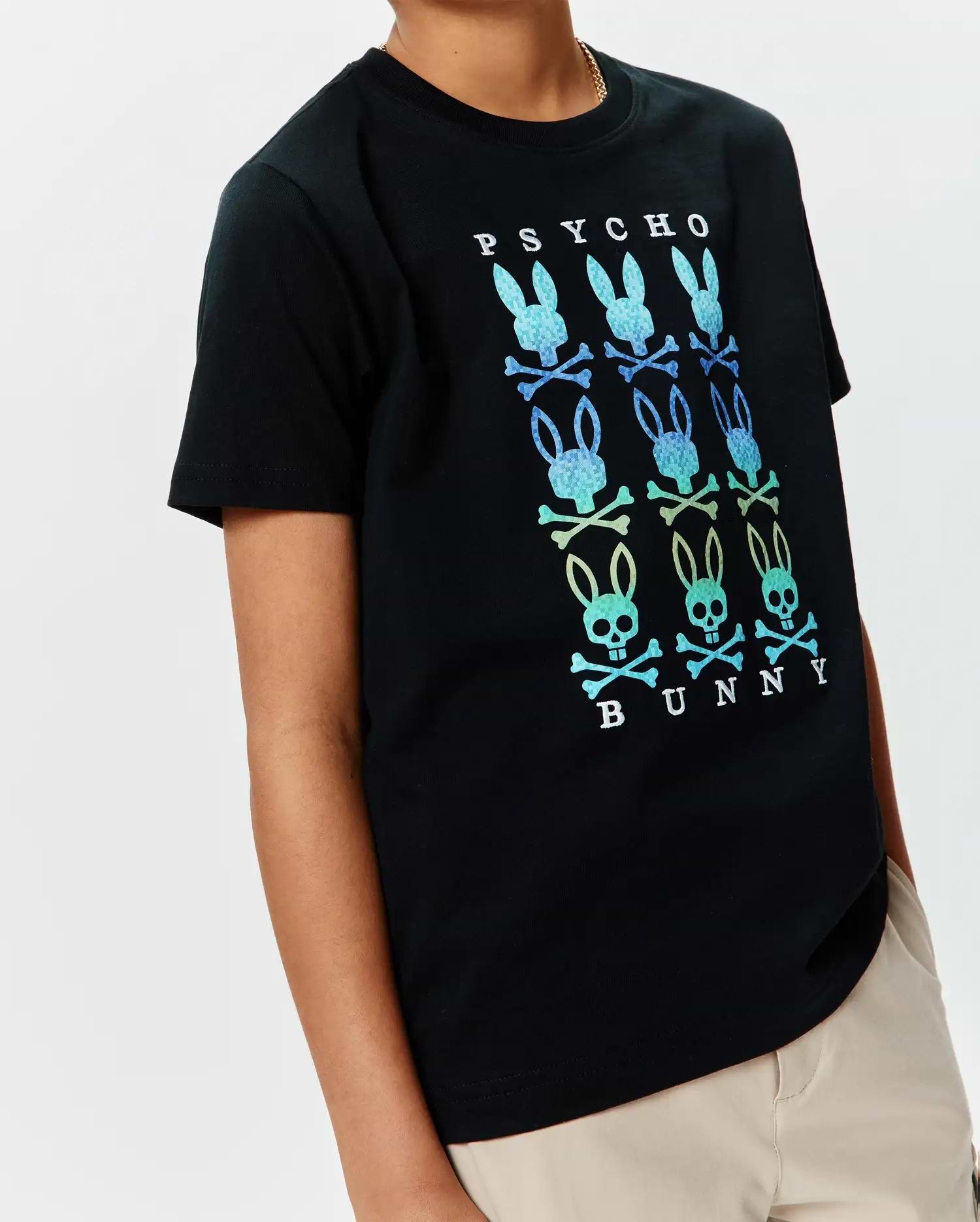 Kids Colt Graphic Tee, a black classic fit jersey t-shirt with a large central gradient blue-green-yellow Psycho Bunny skull and crossbones graphic, featuring PSYCHO text above and BUNNY text below.