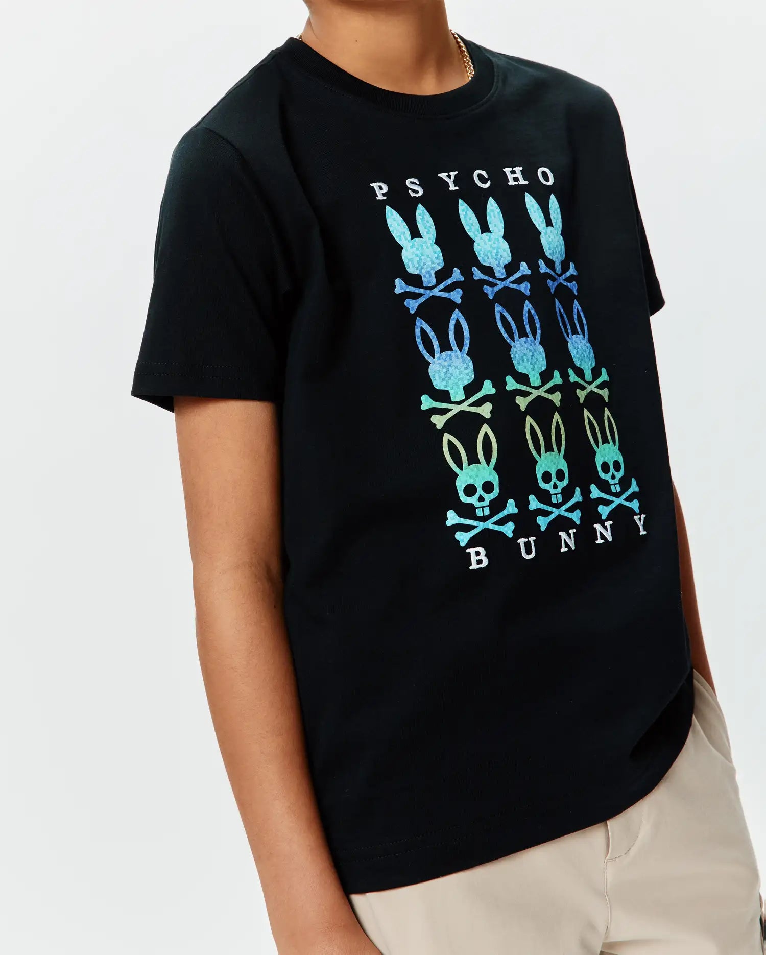 Kids Colt Graphic Tee, a black classic fit jersey t-shirt with a large central gradient blue-green-yellow Psycho Bunny skull and crossbones graphic, featuring PSYCHO text above and BUNNY text below.