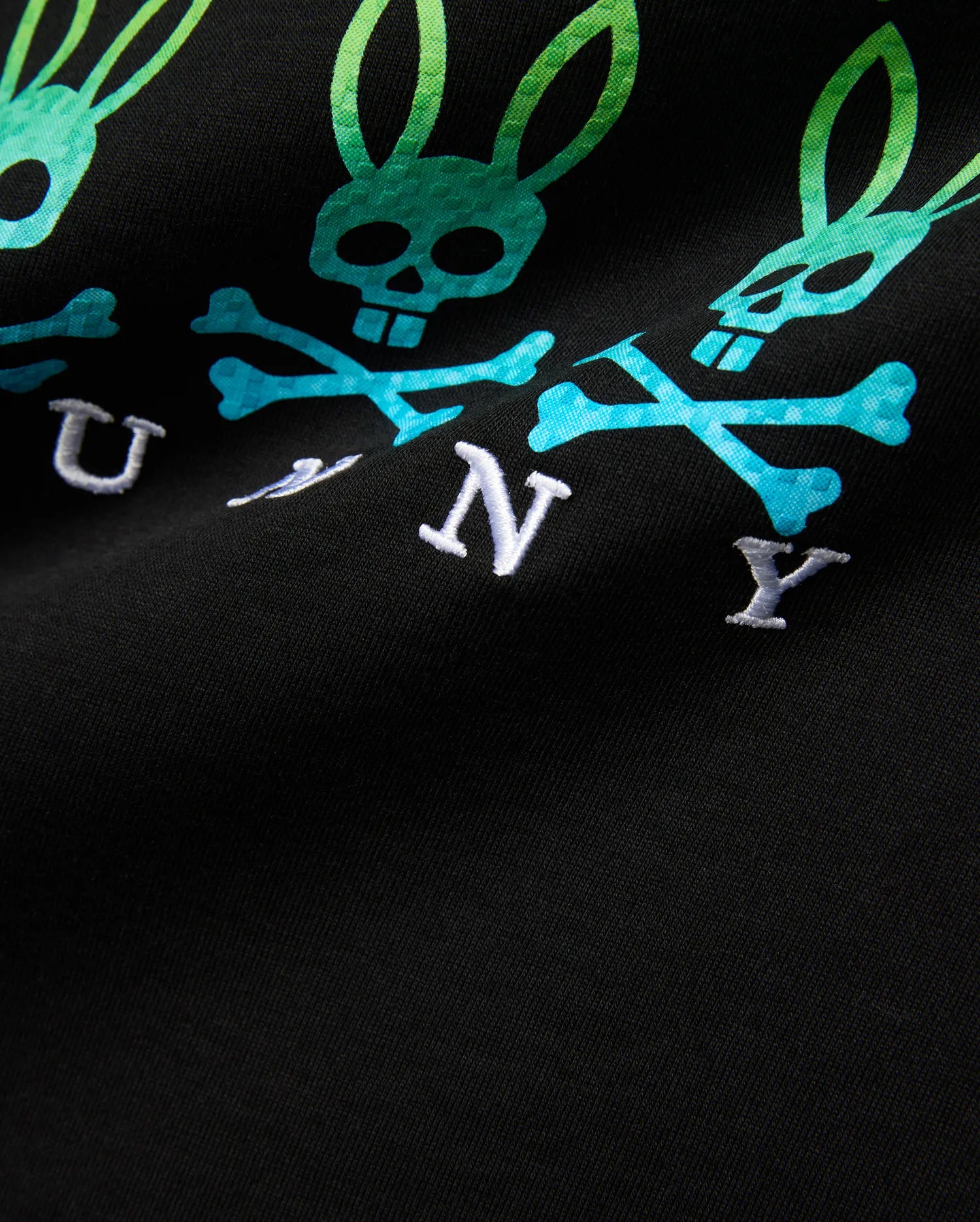Kids Colt Graphic Tee, black jersey t-shirt with a large gradient green to blue bunny skull and crossbones graphic, featuring white embroidered BUNNY text.