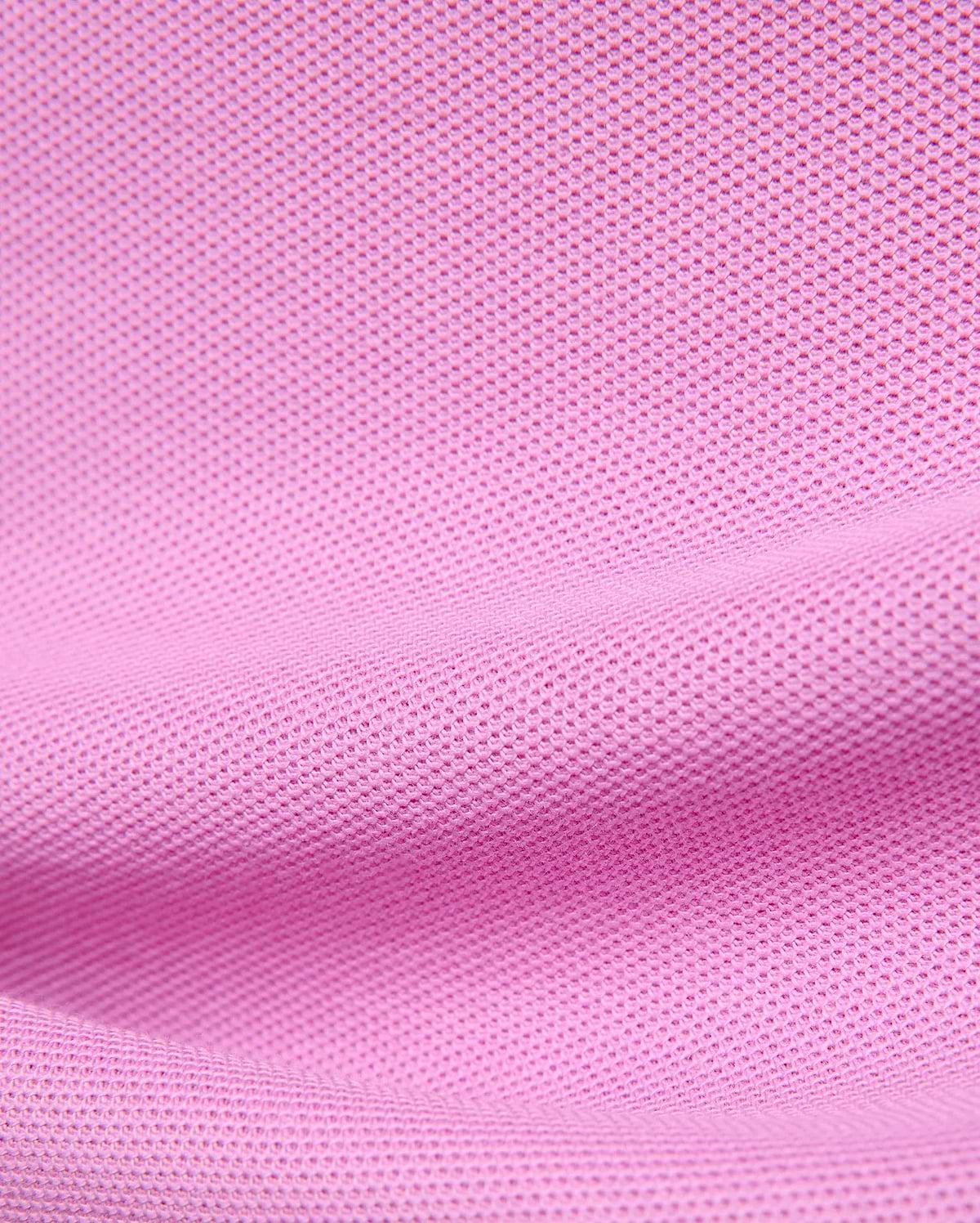 Premium Kids Taylor Pique Tee in vibrant pink, showcasing the refined textured pique knit fabric, a classic fit, and the iconic embroidered Psycho Bunny skull logo on the chest.
