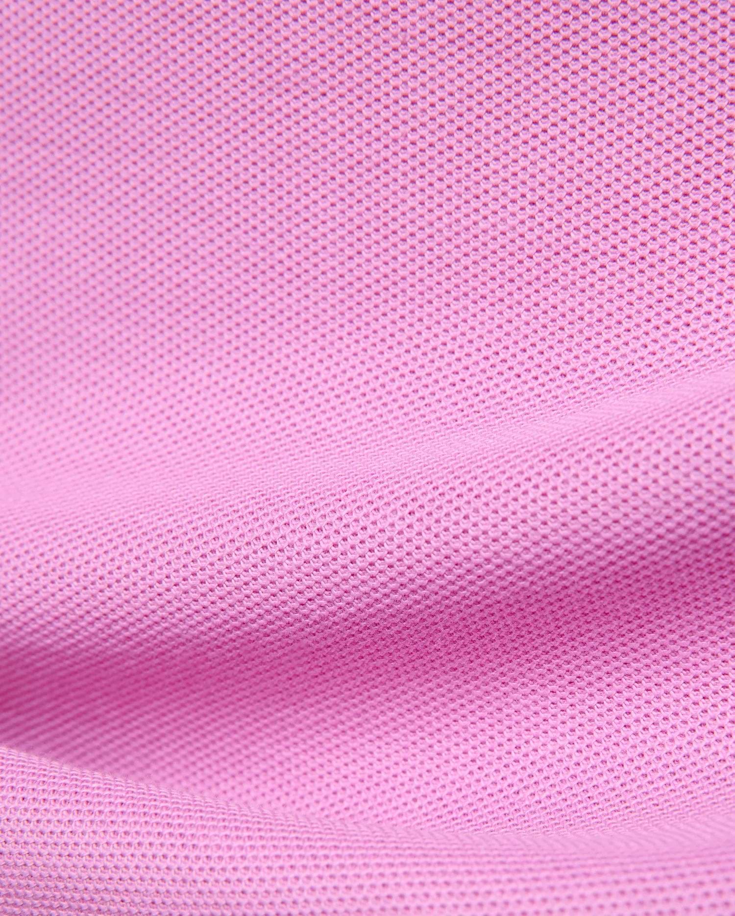Premium Kids Taylor Pique Tee in vibrant pink, showcasing the refined textured pique knit fabric, a classic fit, and the iconic embroidered Psycho Bunny skull logo on the chest.