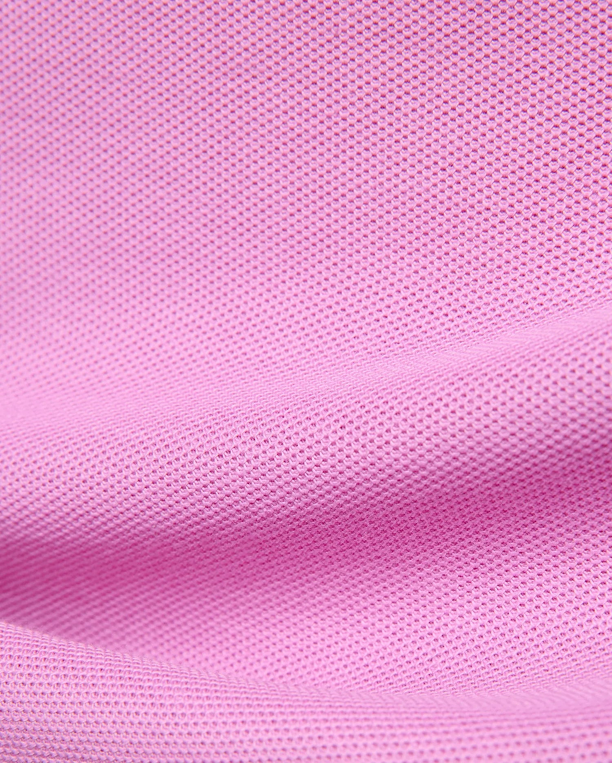 Premium Kids Taylor Pique Tee in vibrant pink, showcasing the refined textured pique knit fabric, a classic fit, and the iconic embroidered Psycho Bunny skull logo on the chest.