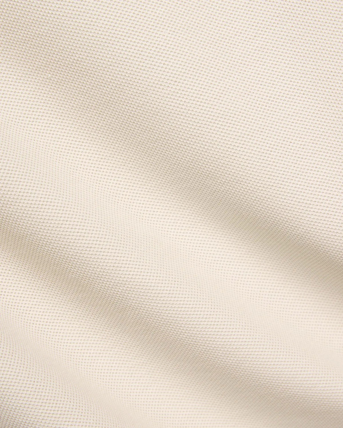 Kids Taylor Pique Tee fabric swatch, a premium light beige pique knit with a subtle, refined texture, embodying the brand's quality for comfortable, stylish streetwear.