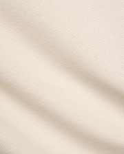 Kids Taylor Pique Tee fabric swatch, a premium light beige pique knit with a subtle, refined texture, embodying the brand's quality for comfortable, stylish streetwear.