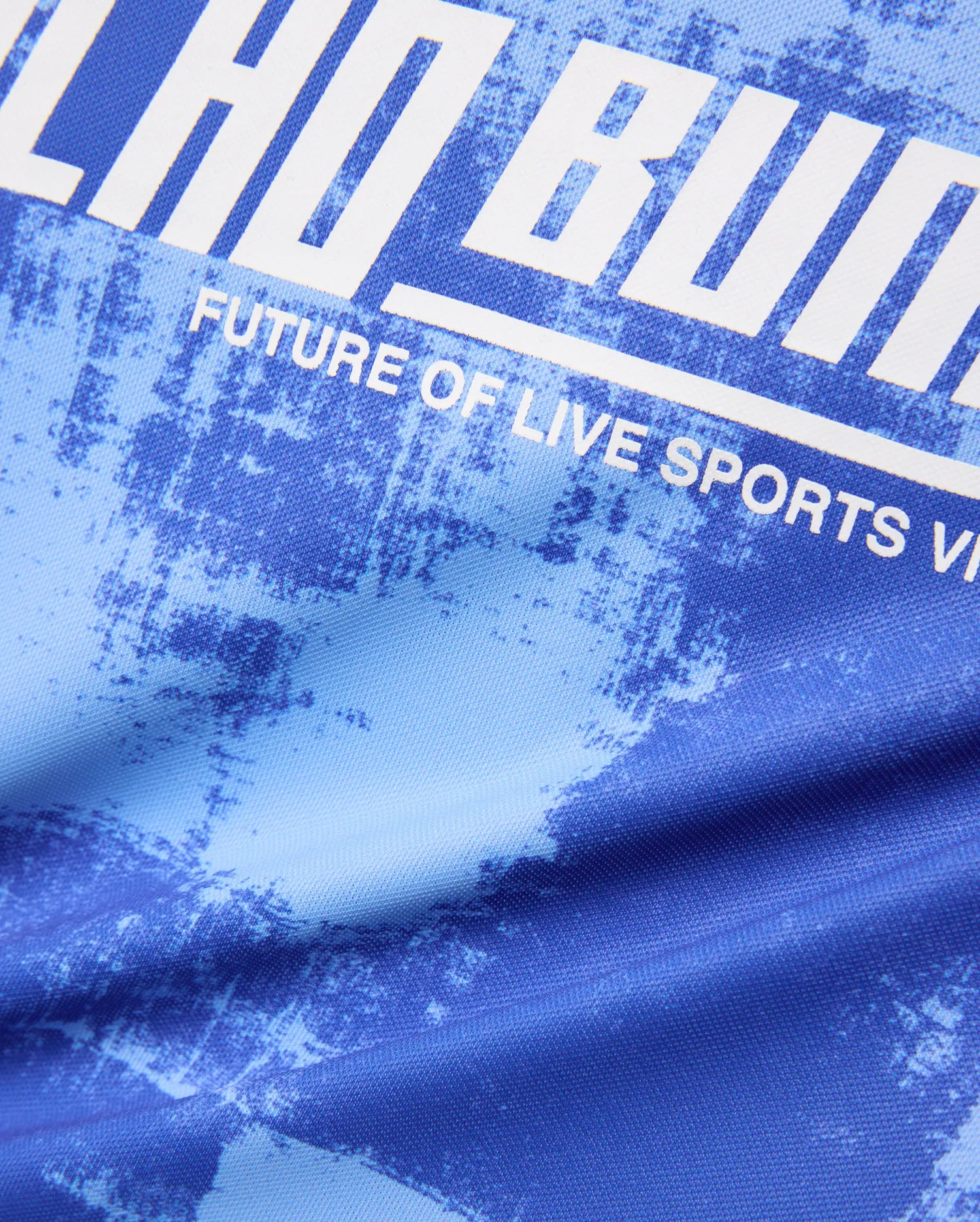 Kids Micah Oversized Soccer Jersey in royal blue with a light blue distressed abstract pattern, featuring a large white graphic print of Psycho Bunny text and FUTURE OF LIVE SPORTS.