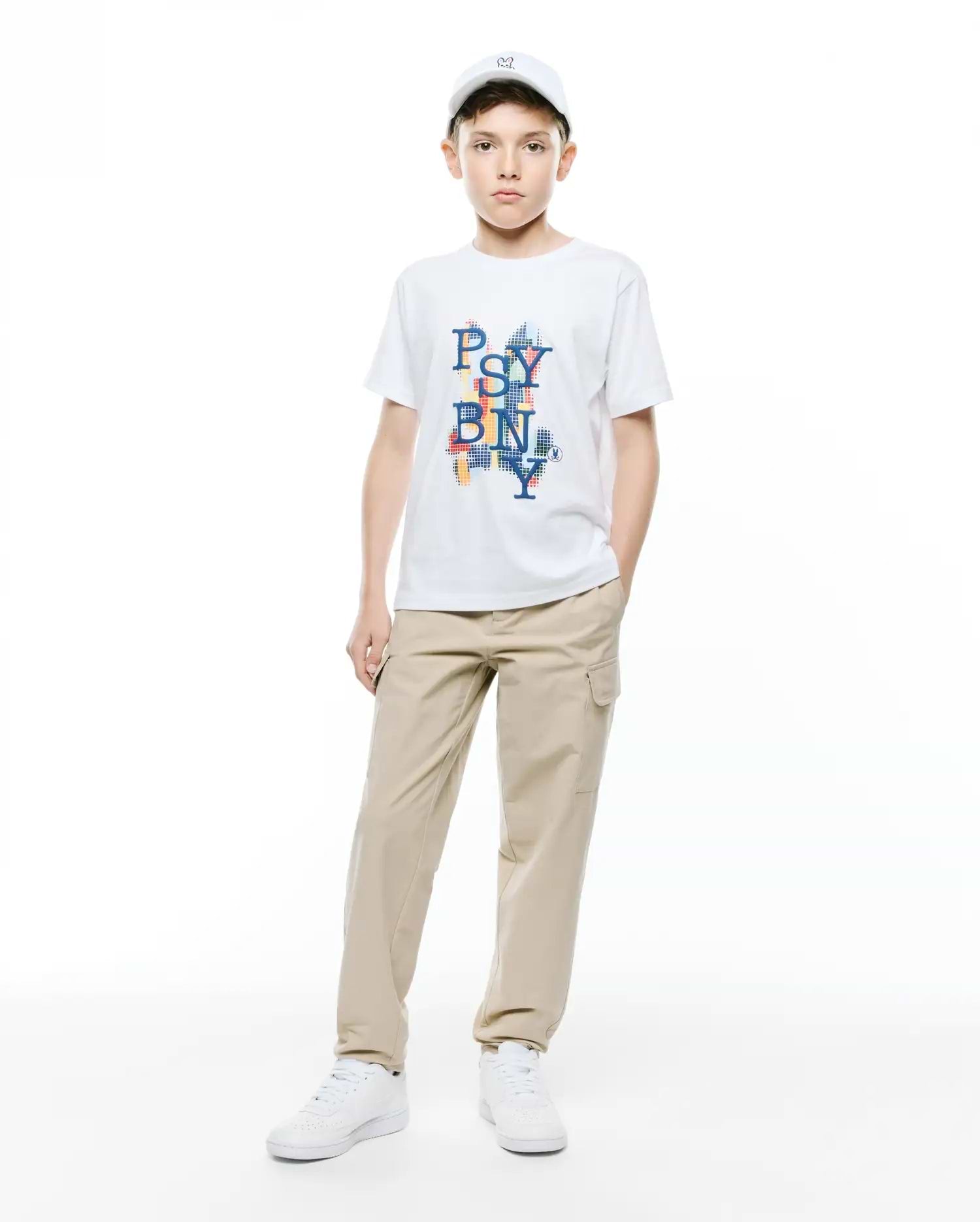 Kids Wes Graphic Tee, a white classic fit soft jersey t-shirt with a vibrant, pixelated multicolor PSY BN NY chest graphic featuring a small Psycho Bunny skull logo.