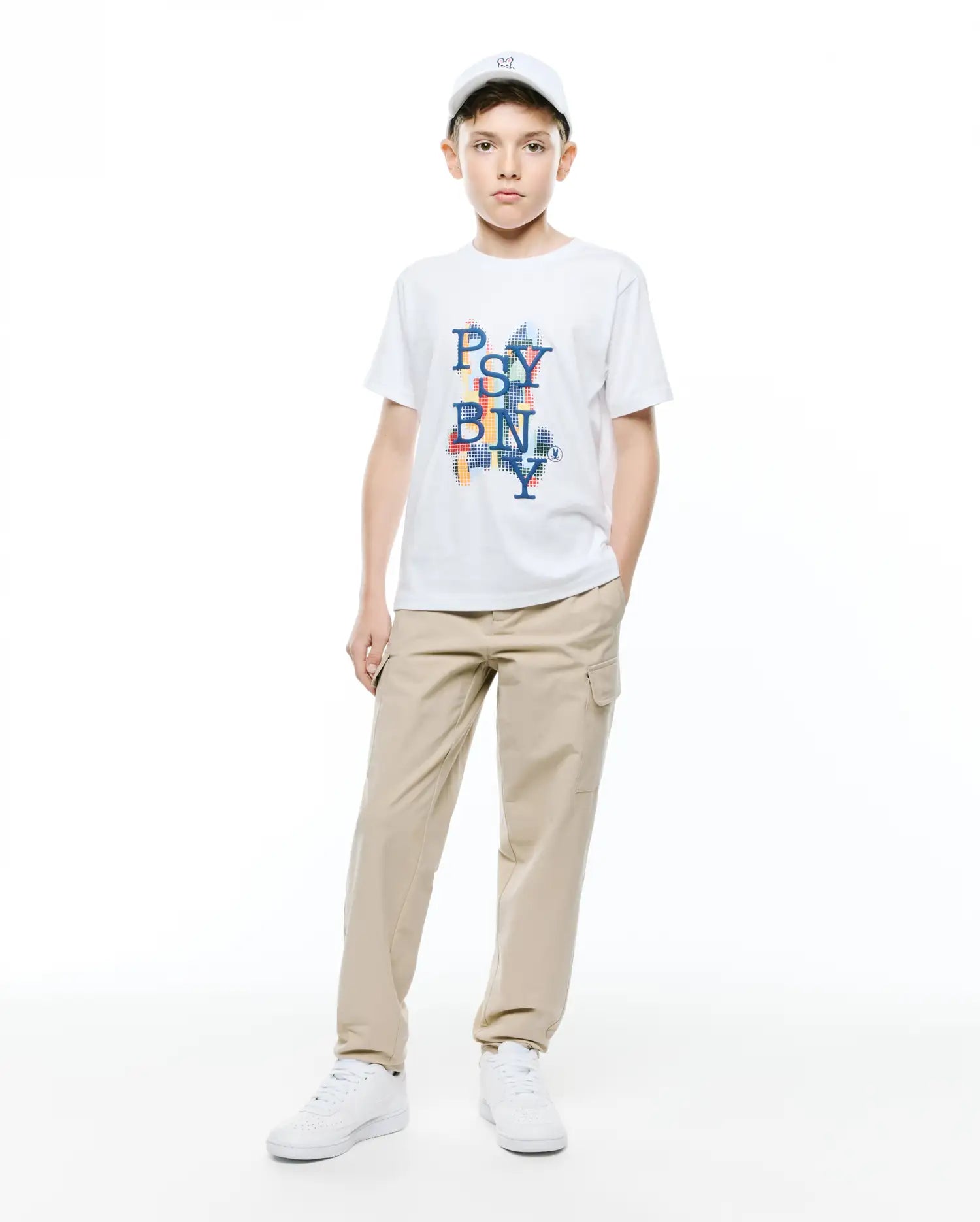 Kids Wes Graphic Tee, a white classic fit soft jersey t-shirt with a vibrant, pixelated multicolor PSY BN NY chest graphic featuring a small Psycho Bunny skull logo.