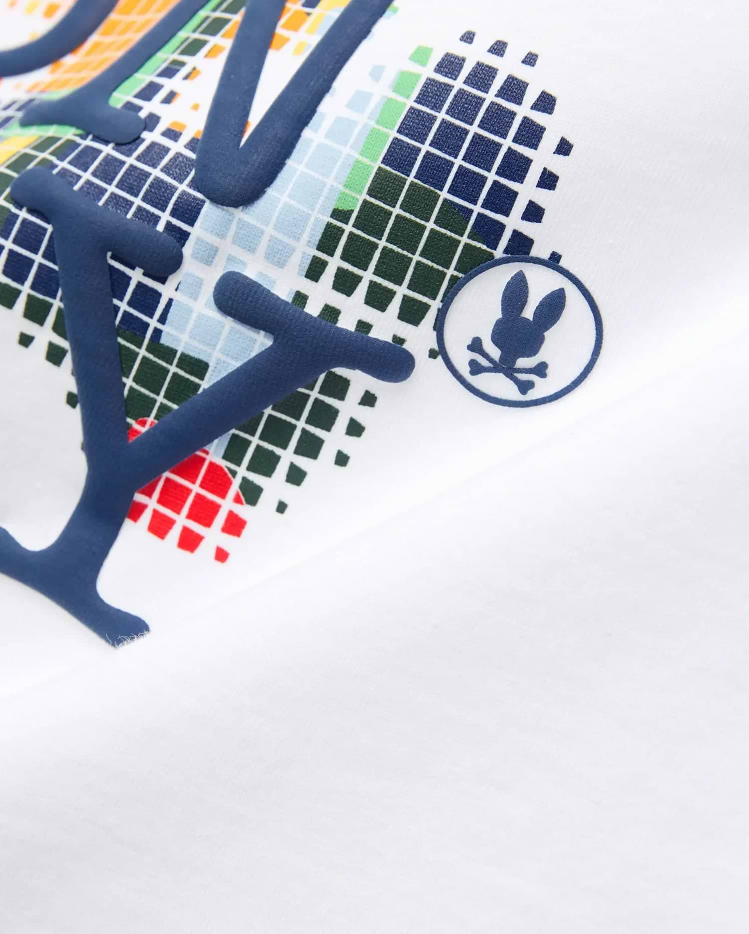 White Kids Wes Graphic Tee featuring a bold, raised navy blue letter graphic over a vibrant pixelated pattern, with a small navy Psycho Bunny skull logo on the chest.
