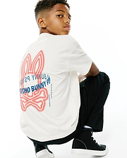 Kids Alex Relaxed Back Graphic Tee, a cream soft jersey relaxed fit t-shirt featuring a large red dotted outline Psycho Bunny skull logo and blue Psycho Bunny text graphic on the back.