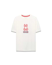 Kids Alex Relaxed Back Graphic Tee, an ecru jersey t-shirt with a relaxed fit, features a large central red and blue Psycho Bunny skull logo and repeated text graphic on the front, accented by a red inner collar.