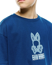 Kids Alex Relaxed Back Graphic Tee, a deep royal blue jersey shirt with a large, textured white and light blue outlined Psycho Bunny skull and stacked text graphic.