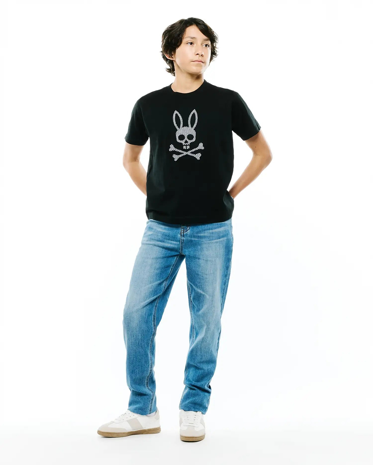 Kids Stan Graphic Tee, a black classic fit jersey t-shirt featuring a prominent white dotted Psycho Bunny skull and crossbones logo centrally placed on the chest.