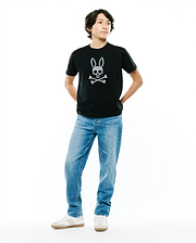 Kids Stan Graphic Tee, a black classic fit jersey t-shirt featuring a prominent white dotted Psycho Bunny skull and crossbones logo centrally placed on the chest.