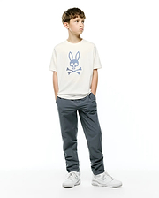 Kids Stan Graphic Tee, an off-white jersey t-shirt with a large blue checkered Psycho Bunny skull and crossbones logo centered on the chest, classic fit.