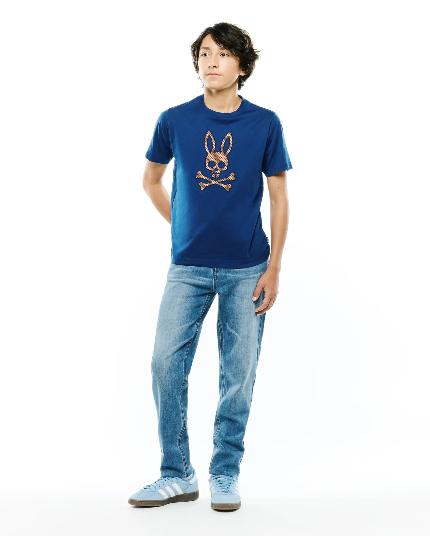 Kids Stan Graphic Tee, a royal blue classic fit jersey t-shirt featuring a large, centered orange honeycomb Psycho Bunny skull logo on the chest.