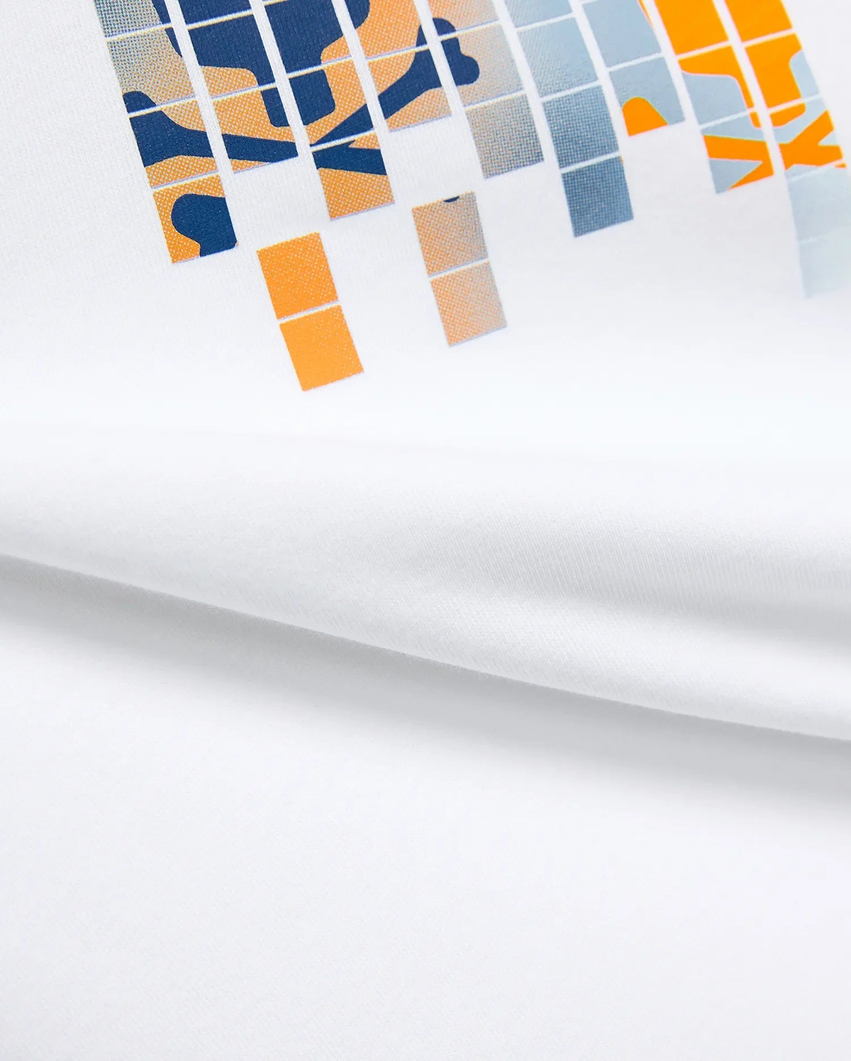 Kids Zander Graphic Tee, white jersey t-shirt with a large, bold pixelated chest graphic in navy, orange, and light blue, featuring abstract shapes for a modern streetwear look.