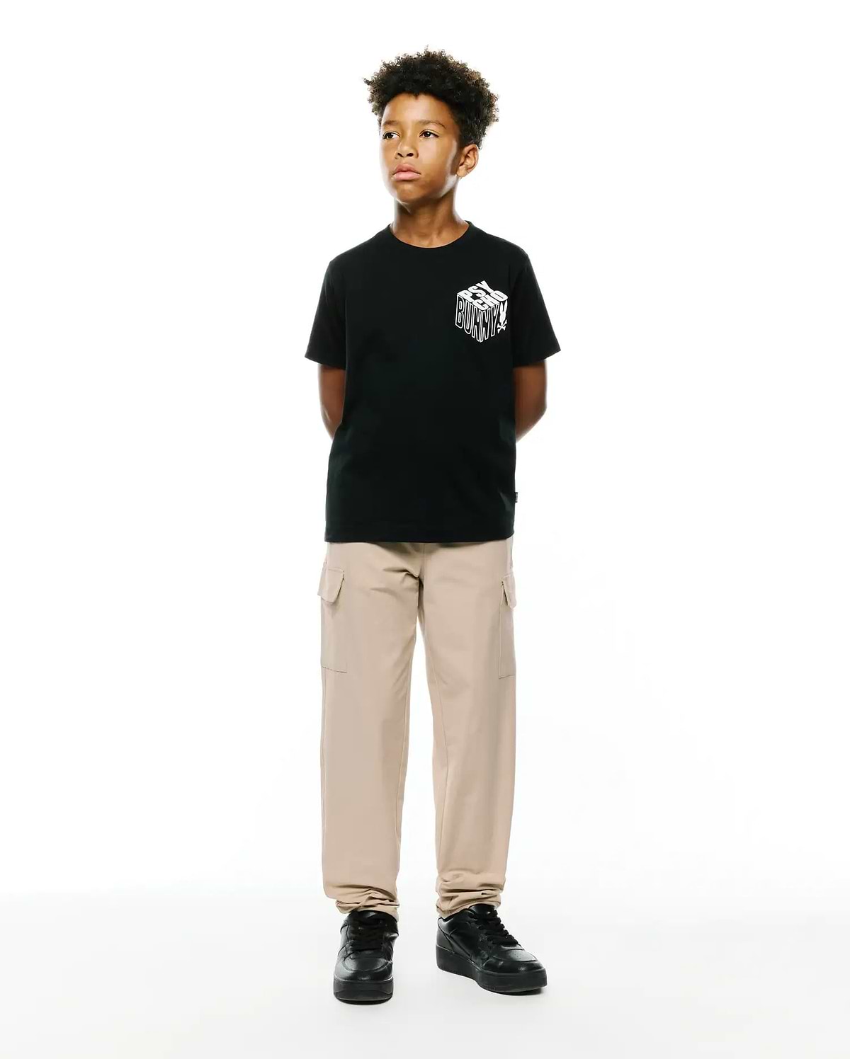 Kids Conan Back Graphic Tee, a black classic fit jersey t-shirt with a bold white 3D-effect Psycho Bunny text graphic prominently displayed on the front chest.