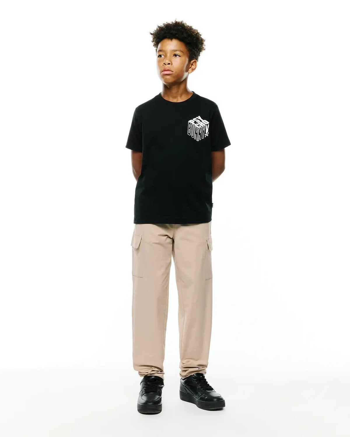 Kids Conan Back Graphic Tee, a black classic fit jersey t-shirt with a bold white 3D-effect Psycho Bunny text graphic prominently displayed on the front chest.