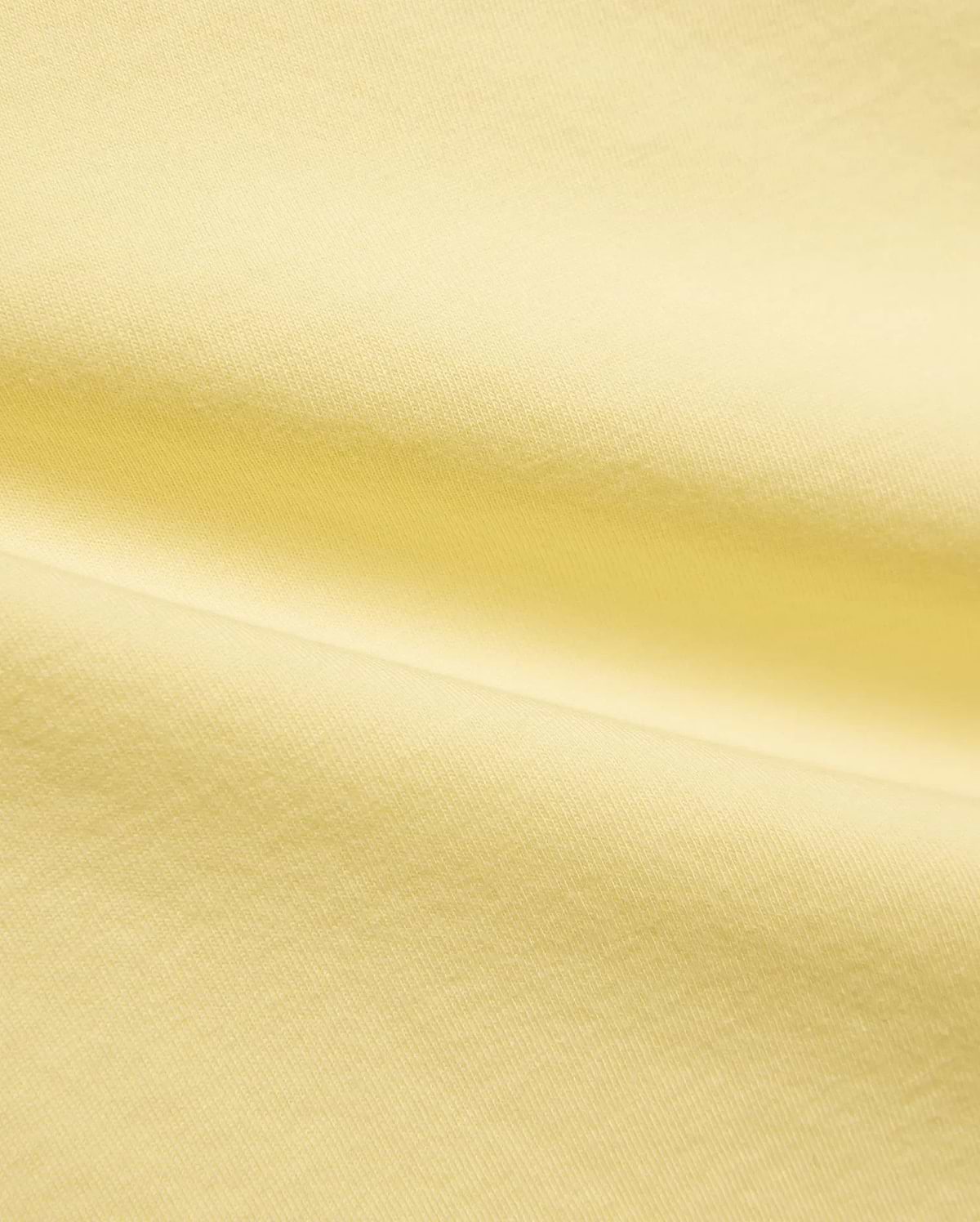 Kids Jaydon Wordmark Graphic Tee, a vibrant yellow Psycho Bunny t-shirt crafted from soft, breathable jersey knit fabric, featuring a bold wordmark graphic, embodying the brand's refined streetwear aesthetic.