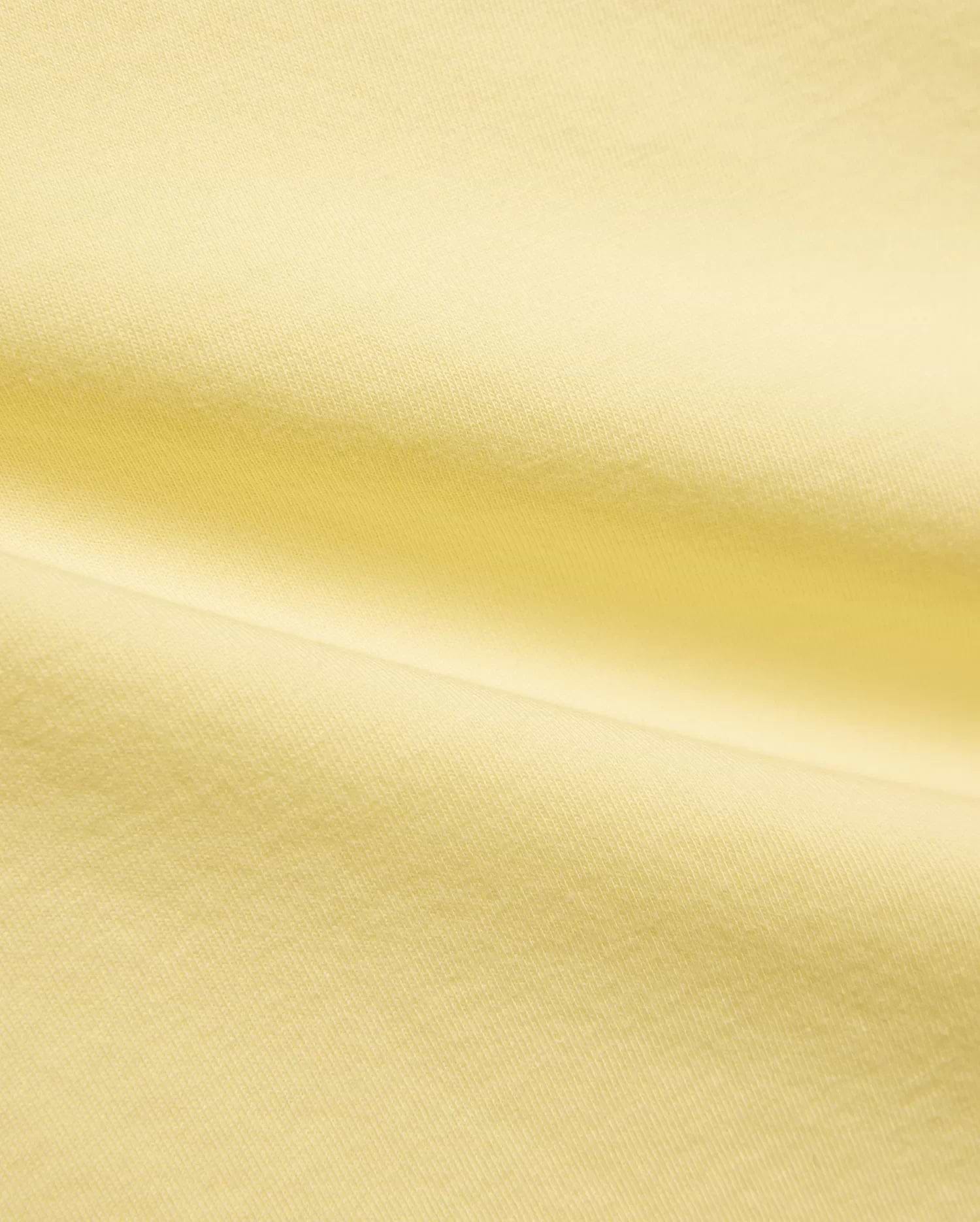 Kids Jaydon Wordmark Graphic Tee, a vibrant yellow Psycho Bunny t-shirt crafted from soft, breathable jersey knit fabric, featuring a bold wordmark graphic, embodying the brand's refined streetwear aesthetic.