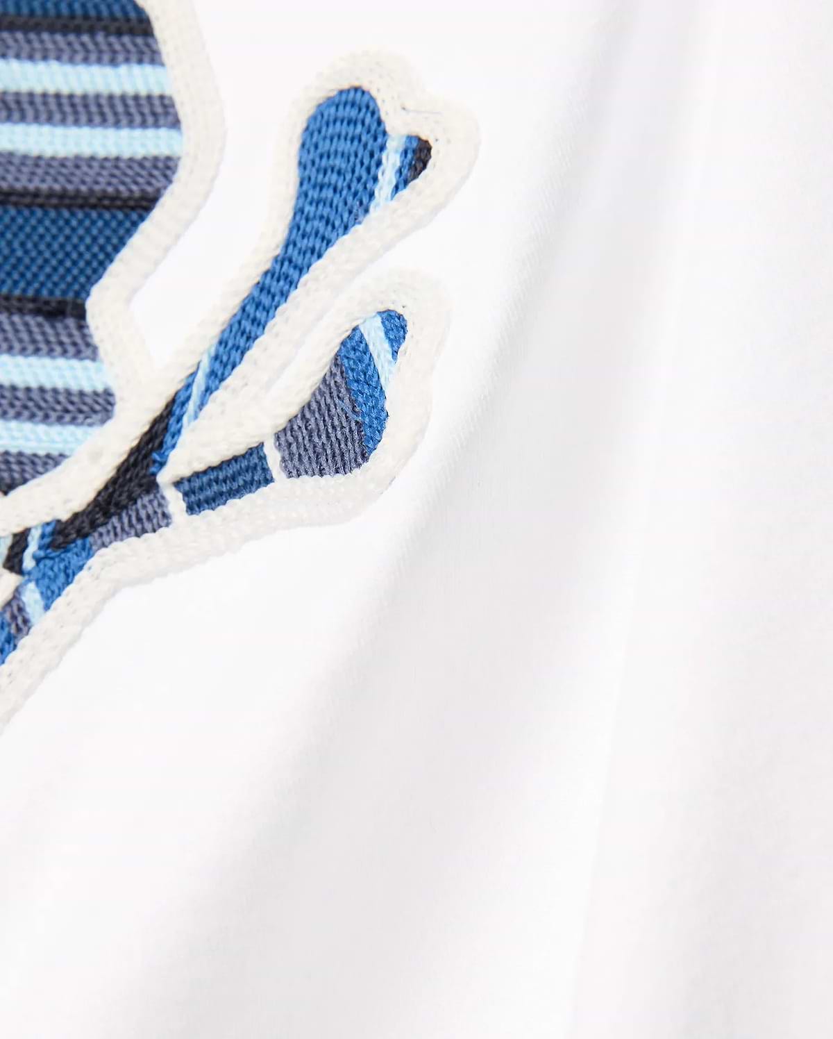 Kids Drew Embroidered Graphic Tee in white jersey, featuring a large, prominent chest Psycho Bunny skull logo with blue, light blue, and dark blue striped embroidery, outlined in white.