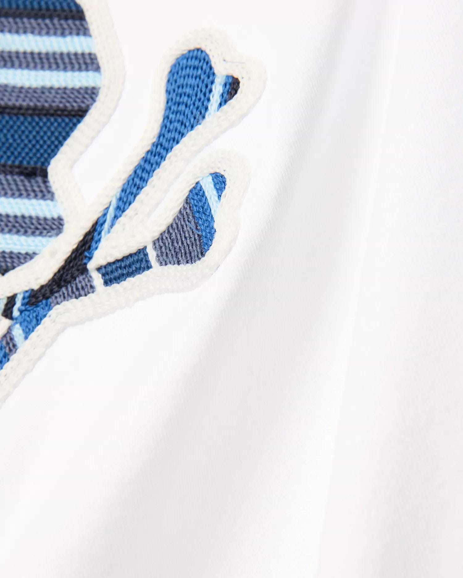 Kids Drew Embroidered Graphic Tee in white jersey, featuring a large, prominent chest Psycho Bunny skull logo with blue, light blue, and dark blue striped embroidery, outlined in white.