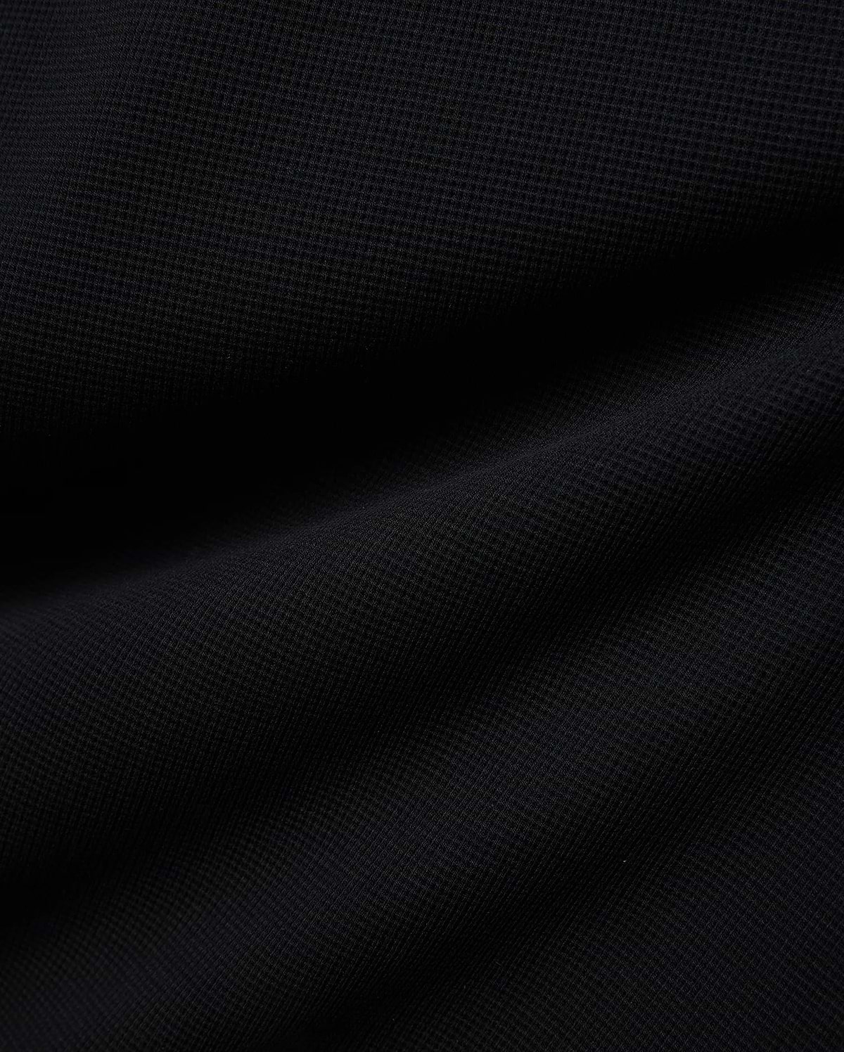 Premium Kids Maxton Waffle Tee in a deep black, featuring a distinct, soft waffle knit fabric texture with subtle raised squares and gentle folds, ensuring comfortable, refined style. (6)