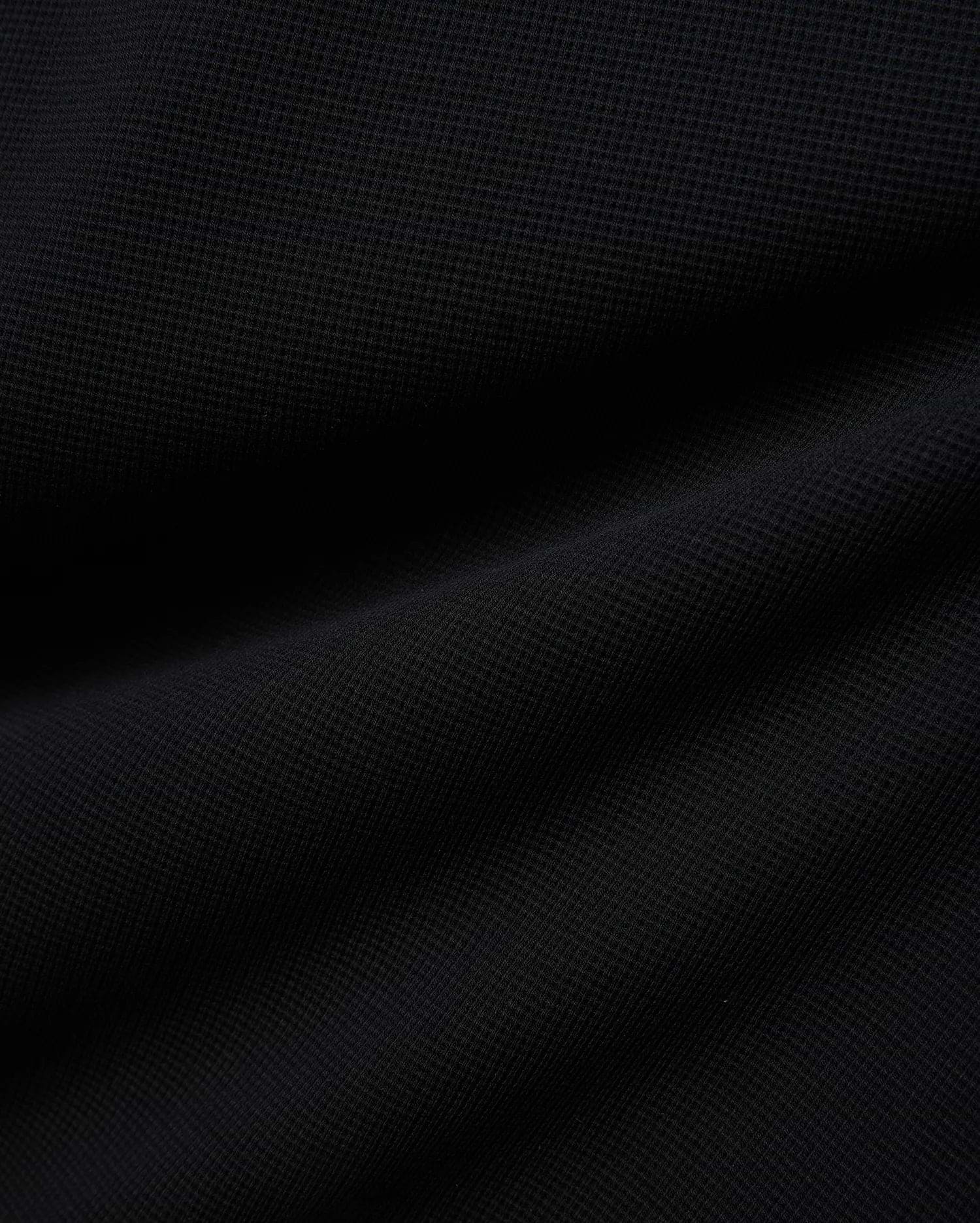 Premium Kids Maxton Waffle Tee in a deep black, featuring a distinct, soft waffle knit fabric texture with subtle raised squares and gentle folds, ensuring comfortable, refined style. (6)